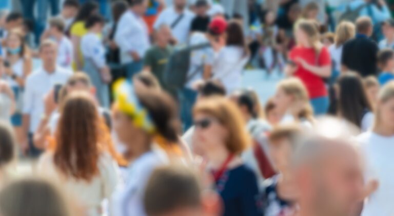Blurred, colorful image with crowd.